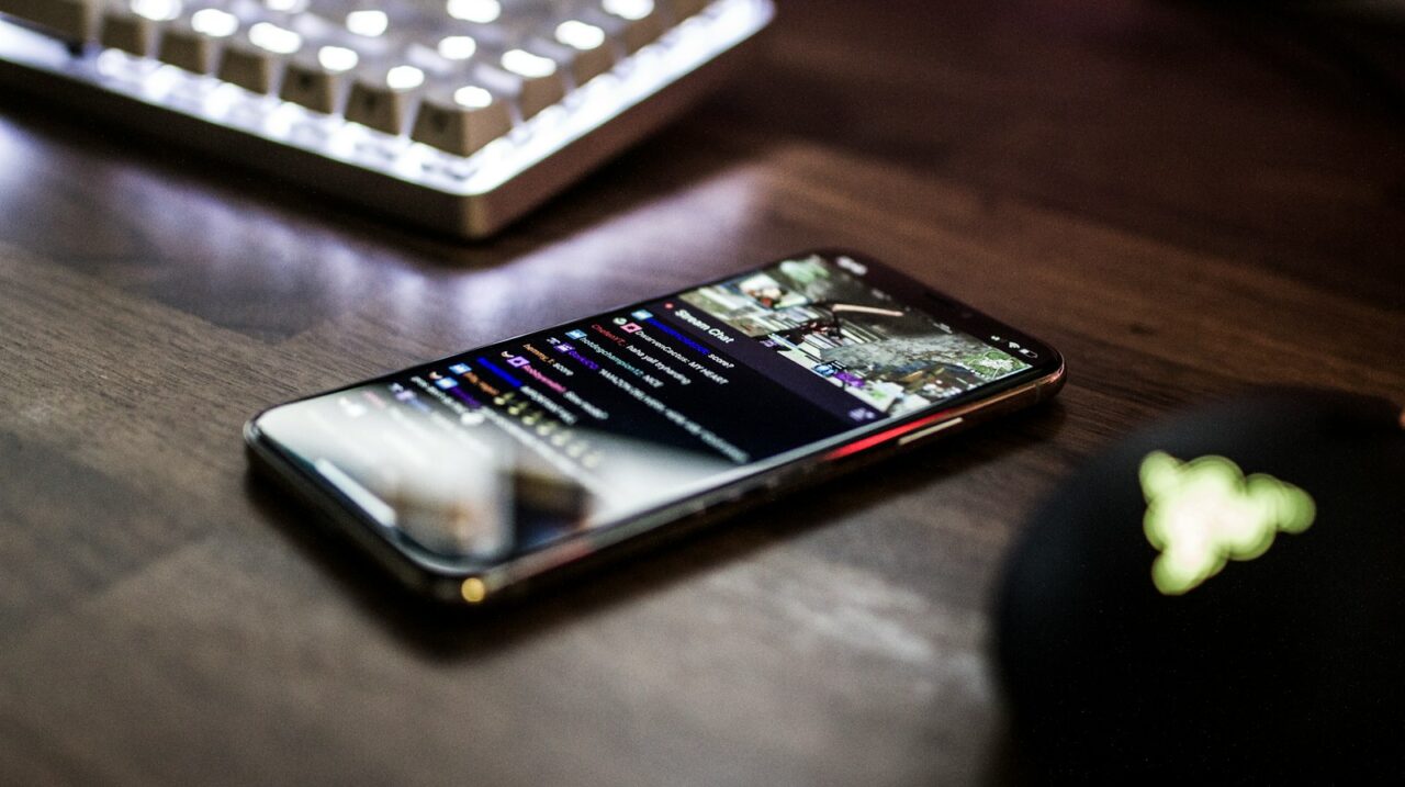 closeup photo of turned on smartphone near keyboard