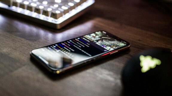 closeup photo of turned on smartphone near keyboard
