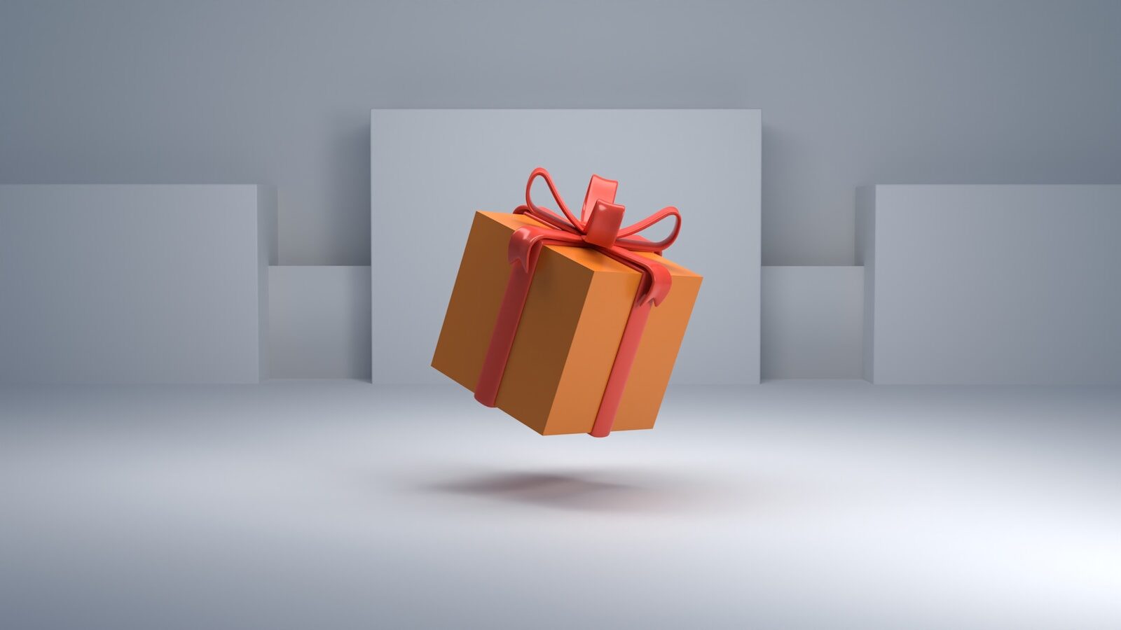 Orangene Geschenkbox mit roter Schleife